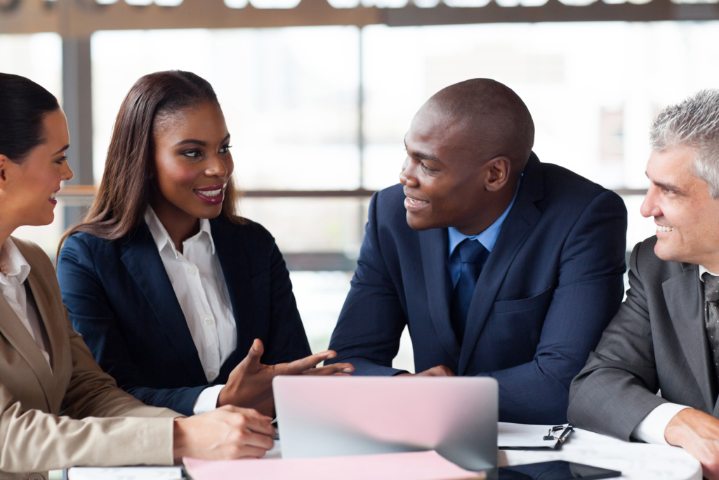 Diverse business owners meeting with advisors to discuss small business loans and cash flow strategies.