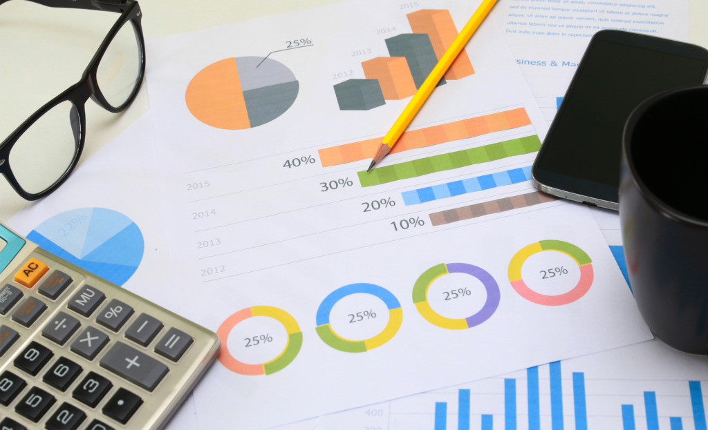 Financial charts and calculator showing cash flow management for small business owners