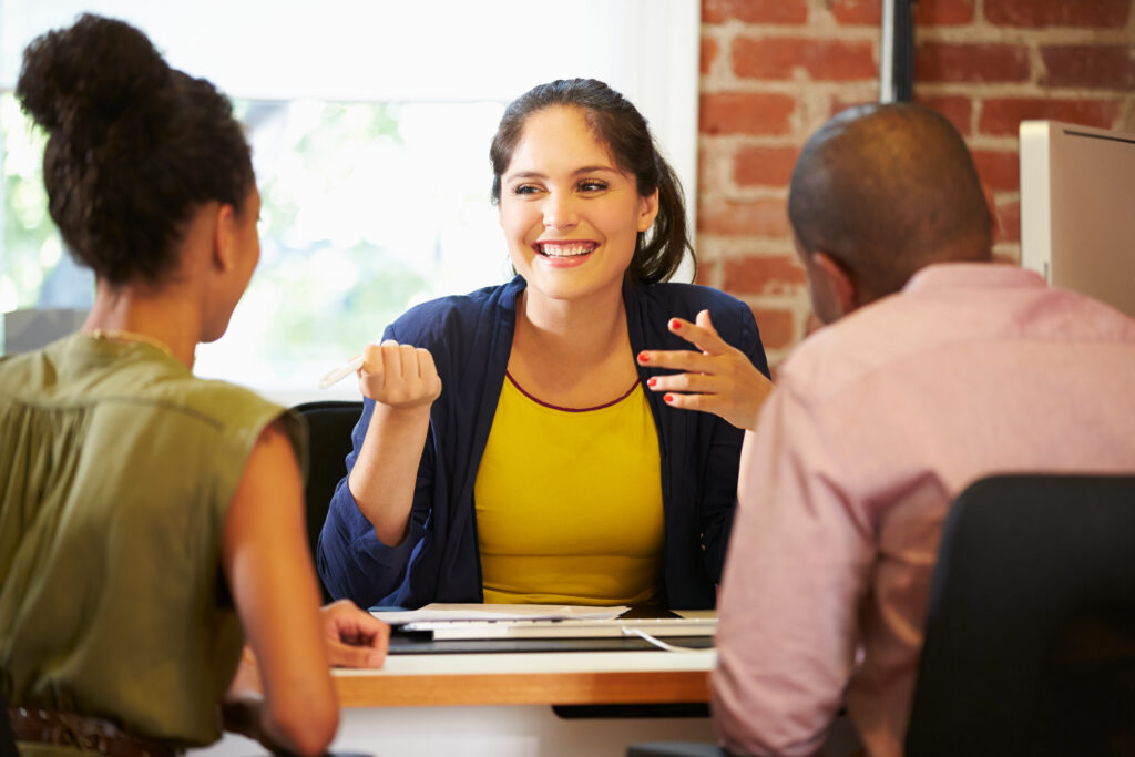 Small business owners meeting with a CPA for financial advice in a modern office setting."